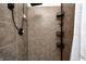 Modern shower with neutral tile and convenient shelving for toiletries and shower essentials at 1295 Longleaf St, Avon, IN 46123