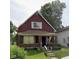 Brick and red-sided house with a front porch and small yard at 1341 N Dearborn St, Indianapolis, IN 46201