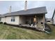 Home featuring a covered patio overlooking the well-maintained backyard at 1348 Mccormicks Cir, Danville, IN 46122