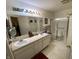 Bathroom features a double sink vanity and a glass-enclosed shower for a modern feel at 1348 Mccormicks Cir, Danville, IN 46122