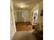 Inviting entryway featuring wood floors, two doors, a decorative table, and access to the kitchen at 1348 Mccormicks Cir, Danville, IN 46122