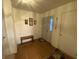 Bright entryway with wood floors, a wooden bench, and a door with decorative glass pane at 1348 Mccormicks Cir, Danville, IN 46122