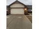 Attached two car garage and driveway of a charming well maintained home at 1348 Mccormicks Cir, Danville, IN 46122