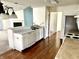 Well-equipped kitchen showcases laminate wood flooring, stainless steel appliances, and breakfast bar at 1348 Mccormicks Cir, Danville, IN 46122