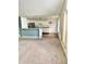 Open-concept kitchen features white cabinets and stainless steel appliances, seamlessly flowing into the living area at 1348 Mccormicks Cir, Danville, IN 46122