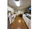 Spacious kitchen with white cabinetry, stainless steel appliances, and a seamless transition to the dining area at 1348 Mccormicks Cir, Danville, IN 46122
