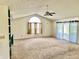 Bright living room showcasing vaulted ceilings, large windows, and access to the outdoors at 1348 Mccormicks Cir, Danville, IN 46122