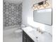 Modern bathroom with white hexagon tile, gold fixtures, and dark vanity at 1523 Marlowe Ave, Indianapolis, IN 46201