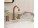 Modern bathroom with gold fixtures and quartz countertop at 1523 Marlowe Ave, Indianapolis, IN 46201