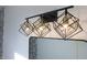 Three-light vanity fixture with geometric metal frame at 1523 Marlowe Ave, Indianapolis, IN 46201