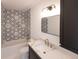 Modern bathroom with hexagon tile, bathtub, and floating vanity at 1523 Marlowe Ave, Indianapolis, IN 46201