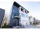 Modern three-story home with dark blue and white exterior, two-car garage, and a balcony at 1523 Marlowe Ave, Indianapolis, IN 46201