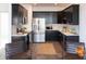 Modern kitchen with dark cabinets, stainless steel appliances, and white quartz countertops at 1523 Marlowe Ave, Indianapolis, IN 46201