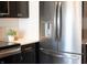 Modern kitchen with stainless steel refrigerator and dark cabinets at 1523 Marlowe Ave, Indianapolis, IN 46201