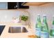 Modern kitchen sink with gold faucet and white herringbone tile backsplash at 1523 Marlowe Ave, Indianapolis, IN 46201