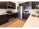 Modern kitchen with stainless steel appliances and dark cabinets at 1523 Marlowe Ave, Indianapolis, IN 46201