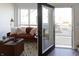 Living room with orange couch and access to a balcony at 1523 Marlowe Ave, Indianapolis, IN 46201