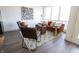 Living room with a brown velvet sofa and two armchairs, a large window, and dark hardwood floors at 1523 Marlowe Ave, Indianapolis, IN 46201