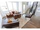 Living room with a brown velvet sofa, two armchairs, and a geometric patterned rug at 1523 Marlowe Ave, Indianapolis, IN 46201