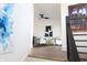 Bright sitting room with two comfy armchairs, a cowhide rug, and modern art at 1523 Marlowe Ave, Indianapolis, IN 46201