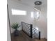 Modern staircase with dark wood floors and a unique light fixture at 1523 Marlowe Ave, Indianapolis, IN 46201