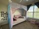 Light-filled bedroom with decorative princess-themed canopy bed near large window at 15314 Mystic Rock Dr, Carmel, IN 46033