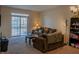 Living room with brown couch, coffee table, and bookcase at 15314 Mystic Rock Dr, Carmel, IN 46033