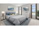 Spacious bedroom with gray bedding, two nightstands, and large windows at 16930 Cole Evans Dr, Noblesville, IN 46060