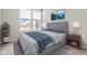 Bedroom with gray bedding, nightstand and large windows at 16930 Cole Evans Dr, Noblesville, IN 46060