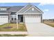 Gray exterior boasts a stone facade, two-car garage, and landscaping at 16930 Cole Evans Dr, Noblesville, IN 46060