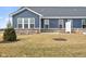 Blue siding home with a backyard patio at 16930 Cole Evans Dr, Noblesville, IN 46060