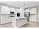 Modern kitchen with white cabinets, stainless steel appliances, and a large island at 16930 Cole Evans Dr, Noblesville, IN 46060
