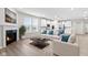 Living room features a corner fireplace and hardwood floors at 16930 Cole Evans Dr, Noblesville, IN 46060