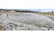 Frozen pond with rock retaining wall at 16930 Cole Evans Dr, Noblesville, IN 46060