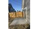Backyard showcasing concrete patio, gray siding, and wood fence at 2426 S Holt S Rd, Indianapolis, IN 46241