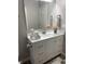Bright bathroom with white vanity, silver hardware, framed mirror, and decor at 2426 S Holt S Rd, Indianapolis, IN 46241