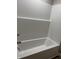Clean white bathtub with integrated shower surround and chrome faucet at 2426 S Holt S Rd, Indianapolis, IN 46241