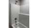 The bathtub features a white shower surround, chrome fixtures, and showerhead at 2426 S Holt S Rd, Indianapolis, IN 46241
