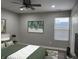A comfortable bedroom featuring a large window and a ceiling fan for cooling at 2426 S Holt S Rd, Indianapolis, IN 46241