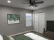 The bedroom has a window, a large closet, a ceiling fan, and modern wall art at 2426 S Holt S Rd, Indianapolis, IN 46241