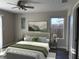 Bedroom with ceiling fan, gray walls, and a plush bed at 2426 S Holt S Rd, Indianapolis, IN 46241