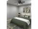 Well-lit bedroom with neutral tones, a ceiling fan, and minimalist wall art at 2426 S Holt S Rd, Indianapolis, IN 46241