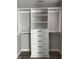 Walk-in closet with custom organization system and hardwood floors at 2426 S Holt S Rd, Indianapolis, IN 46241