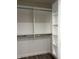 Walk-in closet with adjustable shelves and hanging rods for ample storage at 2426 S Holt S Rd, Indianapolis, IN 46241