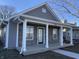 Charming home features stone accents, stylish gray siding, and a welcoming covered front porch at 2426 S Holt S Rd, Indianapolis, IN 46241