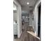 Neutral hallway with hardwood floors and various doorways at 2426 S Holt S Rd, Indianapolis, IN 46241