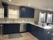 Spacious kitchen featuring navy cabinets, stainless steel appliances, and ample counter space at 2426 S Holt S Rd, Indianapolis, IN 46241
