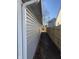 A side yard showing grey vinyl siding and wooden fence at 2426 S Holt S Rd, Indianapolis, IN 46241