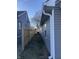 A side yard with gray vinyl siding and wooden fencing at 2426 S Holt S Rd, Indianapolis, IN 46241