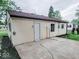 Back of house with a large, cracked concrete patio at 2704 Seminole Dr, Anderson, IN 46012